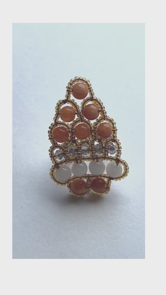 The handcrafted ring is made predominately of red coral beads in varying colors in an organic design which includes seed beads and crystal beads - Sundara Joon