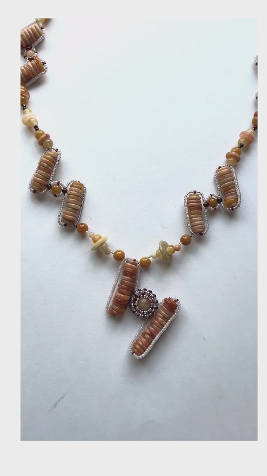 Made predominately of jade beads in variations of cream and tan colors in a pattern that reminds us of steps. This unique design is sure to garner interest. 